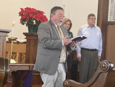 Pastor Mike Klumpp reading the bible in the church